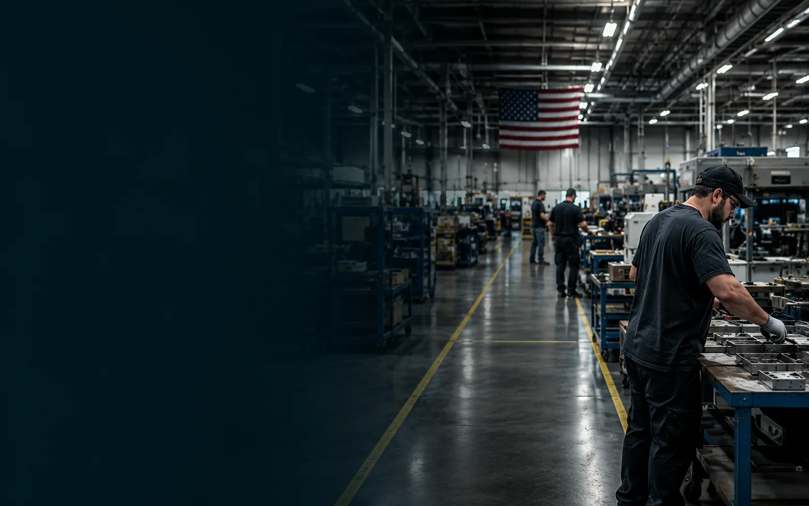 American manufacturing floor with a worker assembling metal components